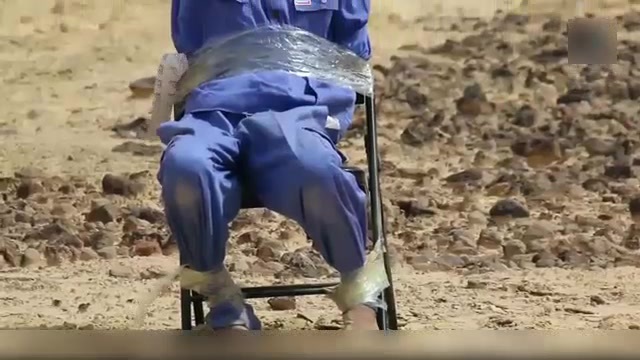 ISIS man shooting prisoner tied to chair