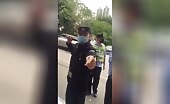 Chinese police attacking an individual of color.