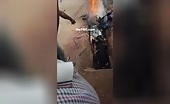Cooking of a man in africa on a shoddy huge fire oven