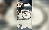 Gawkers recommend a man resting under the tires of a vehicle to t.