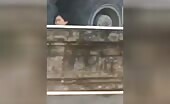 A crushed male keeps an eye out from under the wheel of a truck un