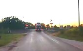 Amtrak train slamming into semi-truck automobile hauler sending cars and truck