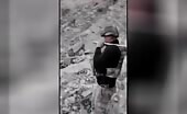 Turkish soldiers handle shattered body of PKK fighter