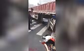 Lady on a scooter under the wheels of a truck d.