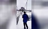 Man falls through ice while walking on frozen lake