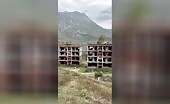 Building collapse aftermath on hillside