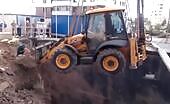 Backhoe tips over while digging, operator trapped inside